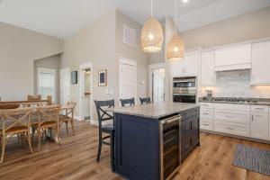 a kitchen and dining room with a table and chairs at LS14 Shelly Shores in Nags Head