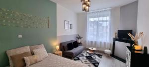 a living room with a couch and a chair at Élégant Appartement Centre Ville - 4 pers in Étaples