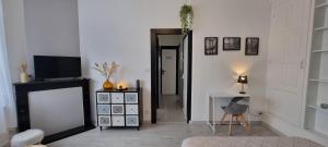 a living room with a television and a table with a chair at Élégant Appartement Centre Ville - 4 pers in Étaples