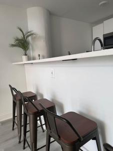 a kitchen with three chairs and a counter with a sink at MEB Loft in Darby