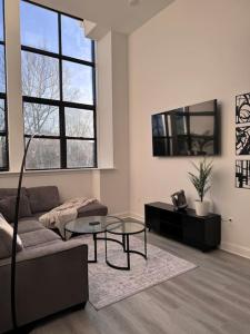 a living room with a couch and a table at MEB Loft in Darby