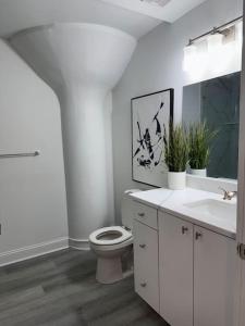 a white bathroom with a toilet and a sink at MEB Loft in Darby