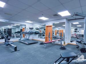 a gym with several treadmills and weights at Gorgeous 1 bedroom with balcony in JVC in Dubai