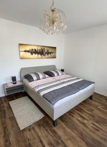 a bedroom with a large bed with a chandelier at Au 10 in St. Wolfgang
