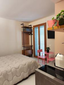 a bedroom with a bed and a table and a chair at CivitaNave in Civitanova Marche