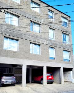 a building with two cars parked in a garage at Dreams in Río Gallegos