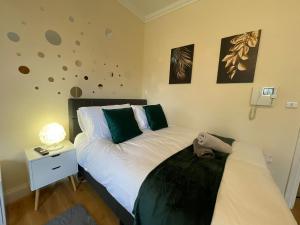 a bedroom with a bed and a side table with a lamp at The Islington Hub in London