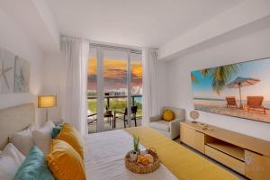a bedroom with a bed with a view of the beach at Infinite Views, Amazing Pool, Gym, Near Beach in Hallandale Beach