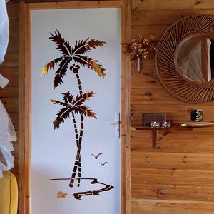 a palm tree sticker on the door of a room at Country Lodge La Pléiade in Sainte-Anne