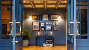 a hallway with blue doors and pictures on the wall at The Ashe Hotel in Tralee