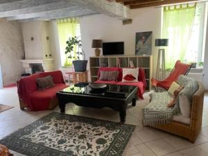 a living room with a couch and a table at La Halte Ligerienne in Saint-Gervais-la-Forêt