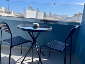 a small table and two chairs on a balcony at Sea Side Rooms in Rhodes Town