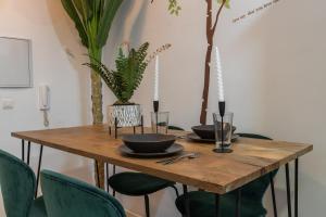 a wooden table with two bowls and plants on it at tuGuest Cetti Meriem Apartment in Granada