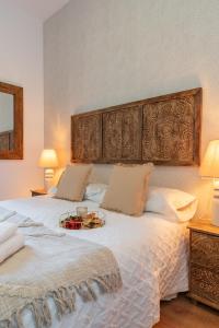 a bedroom with a large bed with a table on it at tuGuest Cetti Meriem Apartment in Granada