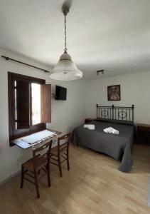 a bedroom with a bed and a table and a desk at Arco Sallustio 2.0 in Monopoli