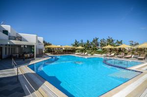 a large swimming pool with blue water at Astir Of Naxos in Naxos Chora