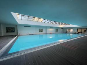 a large swimming pool in a building with a skylight at Punta del Este - Green Life - Top amenities in Punta del Este