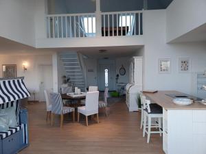 a kitchen and dining room with a table and chairs at Villa Spatzennest in Trent