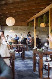 a group of people sitting at tables in a restaurant at Hotel Stelor in Västergarn