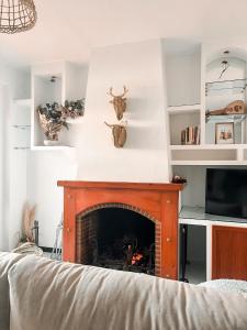 a living room with a fireplace and a tv at Casa Almonte in Almonte