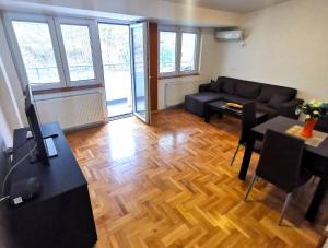 a living room with a couch and a table at Ballet apartament - 2 in Skopje