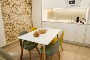 a kitchen with a white table and chairs at Torre Solana 41 in Cádiz