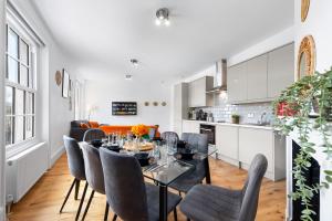 a kitchen and dining room with a table and chairs at Stunning apartment in Kings Cross sleeps 10 in London