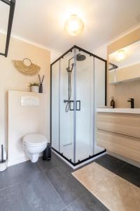 a bathroom with a glass shower and a toilet at KROOST in Lokeren +27 photos