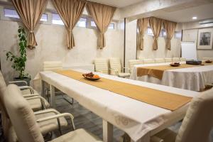 a conference room with white tables and chairs at Hotel Marea Neagra in Sinaia