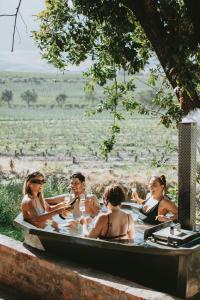 a group of people sitting in a bath tub at Mont Rouge Cottage in Tulbagh