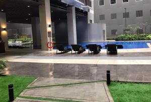 a hotel lobby with chairs and a swimming pool at C Place - Capsule B in Manila