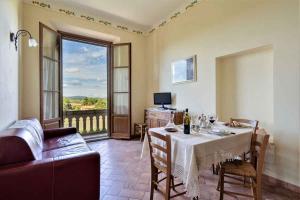 a dining room with a table and a view of a balcony at Apartment in Casole d'Elsa - Toskana 24073 in Casole dʼElsa