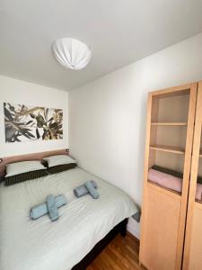 a bedroom with a bed with two blue towels on it at Apartament Sołtysowska- garaż bezpłatny, NEAR Tauron Arena, EXPO in Krakow