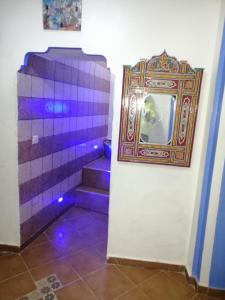 a room with purple stairs and a picture on a wall at Dar issam in Chefchaouene