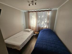 En eller flere senge i et værelse på Departamento Robles del Volcan