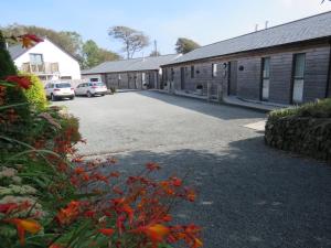 a parking lot in front of a building at Umber, Gallery Cottages, Devon in West Putford