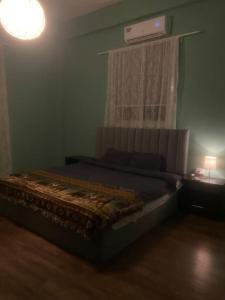 a bedroom with a bed in a room with a window at 3bedrooms apt near paris square in Amman +3 photos