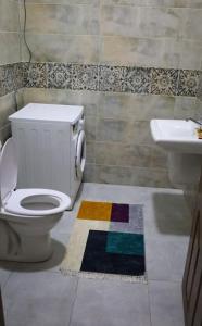 a bathroom with a toilet and a sink at 3bedrooms apt near paris square in Amman