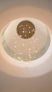 a chandelier hanging from a ceiling in a room at Van der Valk Hotel Delft A4 in Den Hoorn