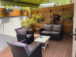a patio with chairs and a table and plants at Chez Arlette in Saint-Louis
