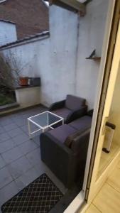 a living room with a couch and a table at Renovated private room in Brussels