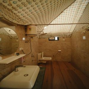 a bathroom with a sink and a mirror at Bharat Lake view Resort- Pure Veg Restaurant in Udaipur