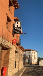un cartello hotel sul lato di un edificio di Hotel el Cid a Torres de Albarracín