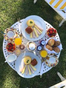 a table with plates of food and drinks on it at CasaIvan in Florianópolis