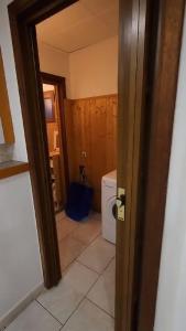 an open door to a bathroom with a washing machine at Renovated private room in Brussels