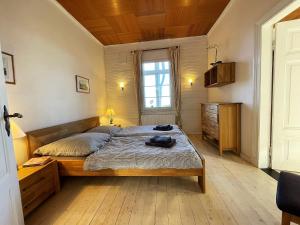 a bedroom with a bed and a window in it at Alleinlage, eingezäunt, Hunde Willkommen, WLAN, Sauna, Kamin in Dornum