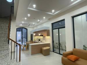 a living room with a kitchen and a dining room at Zen Village Lagi in Lagi