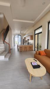 a living room with a couch and a table at Zen Village Lagi in Lagi +26 photos