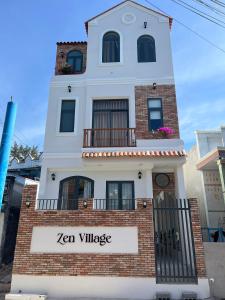 a building with a sign that reads zen village at Zen Village Lagi in La Gi