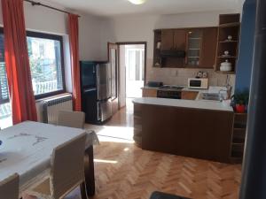 a kitchen with a table and a kitchen with a stove at Apartment Marija in Pula